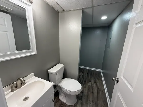 a white toilet sitting next to a bathroom sink