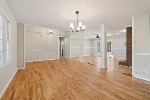 a kitchen with kitchen island a stove a sink and a wooden floors