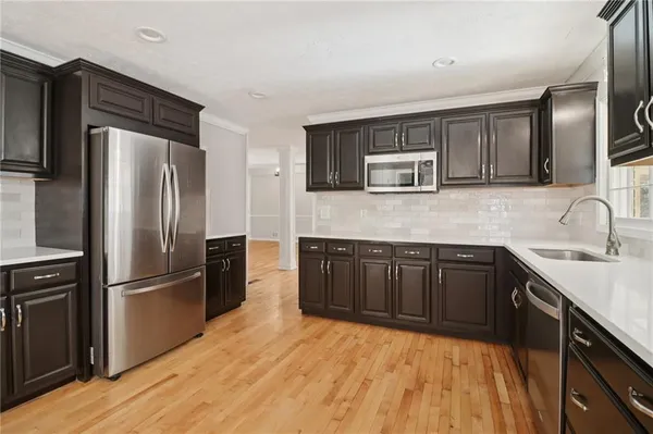 a view of hallway with wooden floor
