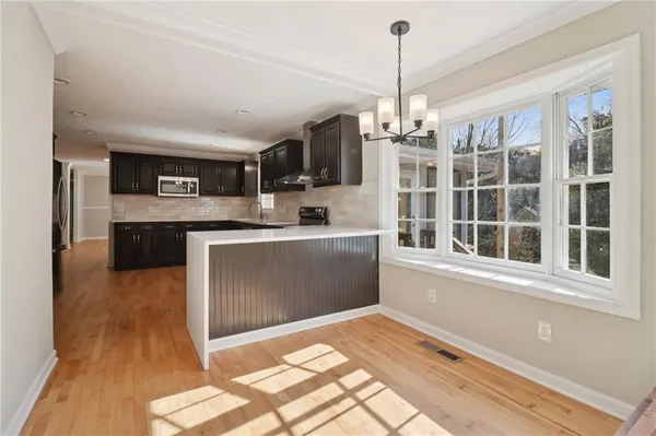 a bathroom with a granite countertop sink a toilet and a mirror