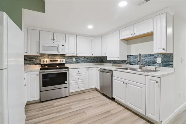 an empty room with windows and closet