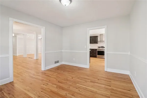 an empty room with windows and closet
