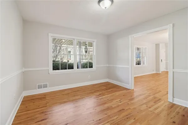 an empty room with windows and closet
