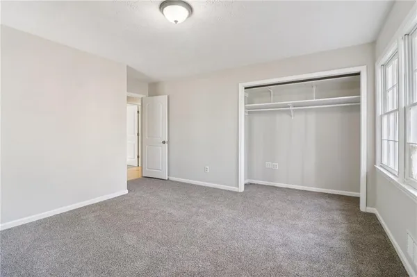 a view of an empty room and wooden floor