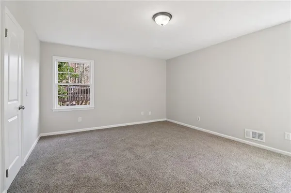 a bathroom with a sink vanity granite tub and a mirror
