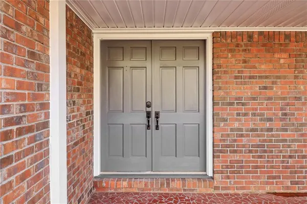 wooden floor fireplace and windows in an empty room