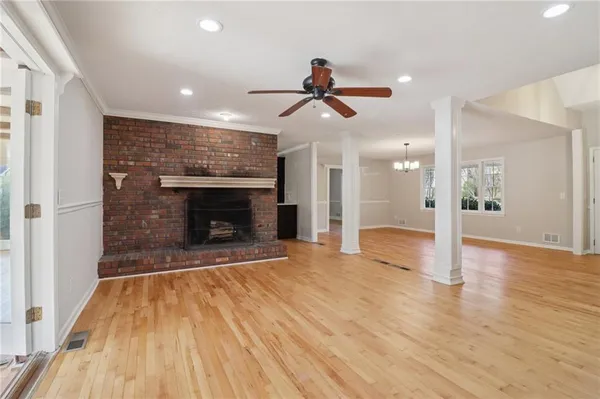 a view of a big room with wooden floor and a bathroom