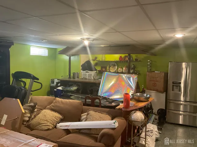 a living room with furniture a air conditioner vent and a large window