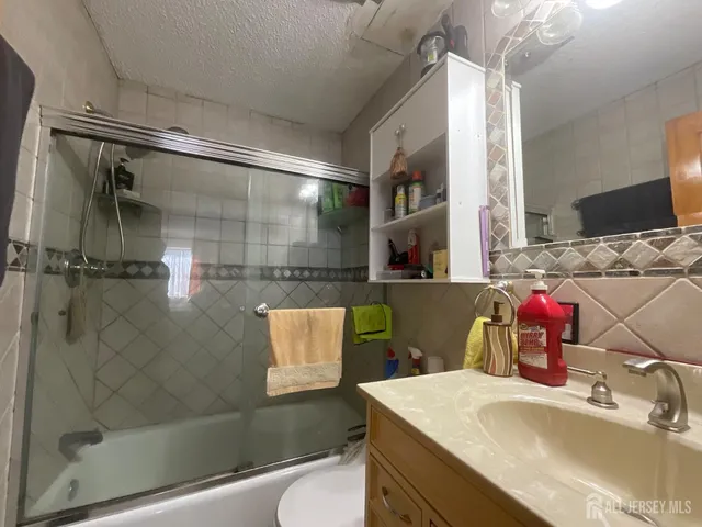 a bathroom with a sink vanity mirror and shower