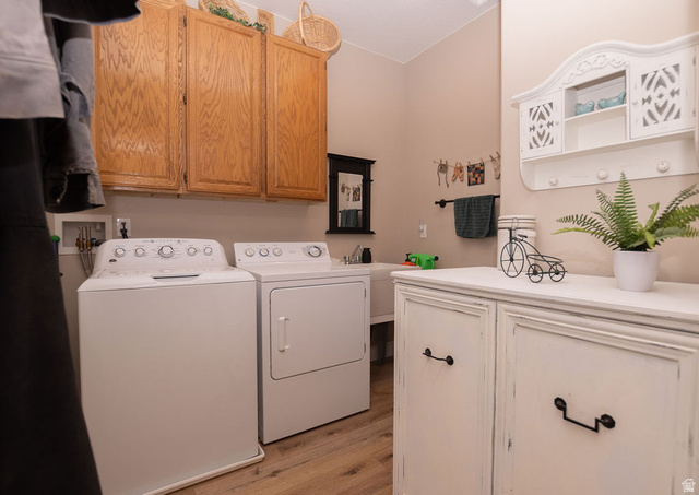 745 East 885 North Beaver, UT 84713 - Photo 35 of 50 Laundry area with cabinet space, light wood-style floors, and washing machine and clothes dryer