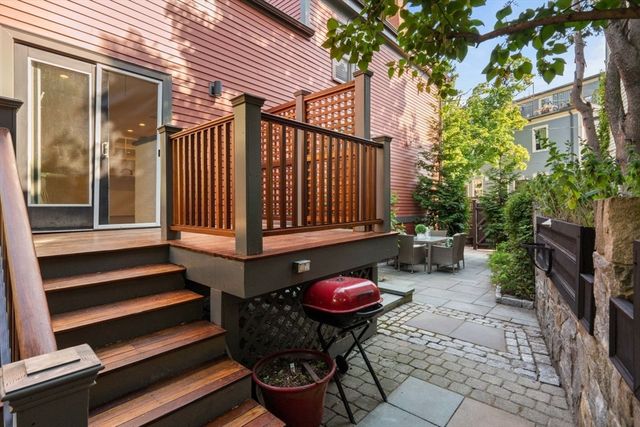a view of a patio with table and chairs and potted plants