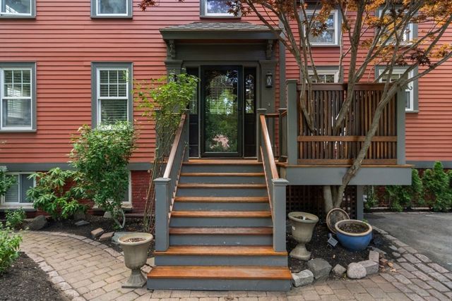 a view of a house with a yard and sitting area