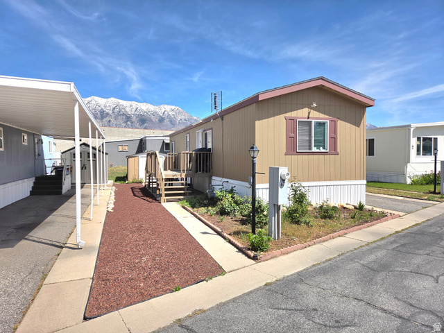 597 North State Street, Unit 67 Orem, UT 84057 - Photo 1 of 23 View of front of home with a storage unit and a deck with mountain view