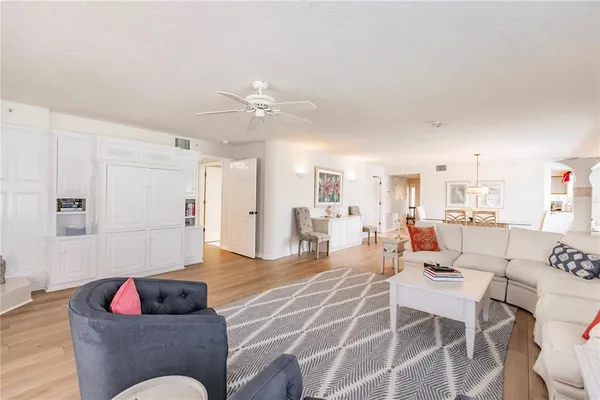 a living room with furniture and kitchen view