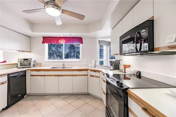 a kitchen with a sink cabinets and window