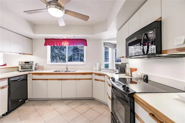 a kitchen with a sink cabinets and window