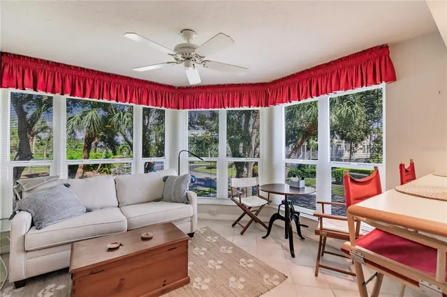 a room with furniture a flat screen tv and a kitchen view