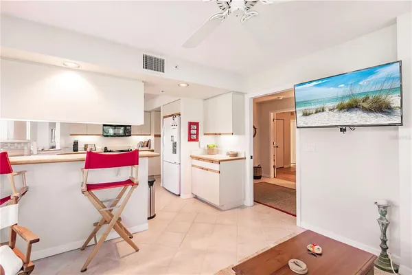 a dining room with furniture and a kitchen view