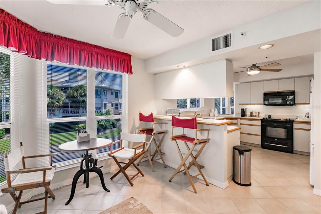 11000 Placida Road, Unit 2201 Placida, FL 33946 - Photo 23 of 43 a dining room with furniture and a kitchen view