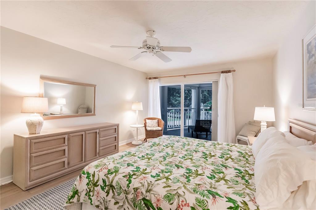 11000 Placida Road, Unit 2201 Placida, FL 33946 - Photo 25 of 43 a bedroom with a large bed and a dresser