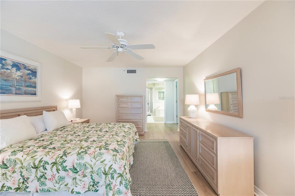 11000 Placida Road, Unit 2201 Placida, FL 33946 - Photo 26 of 43 a bedroom with a large bed and a chandelier