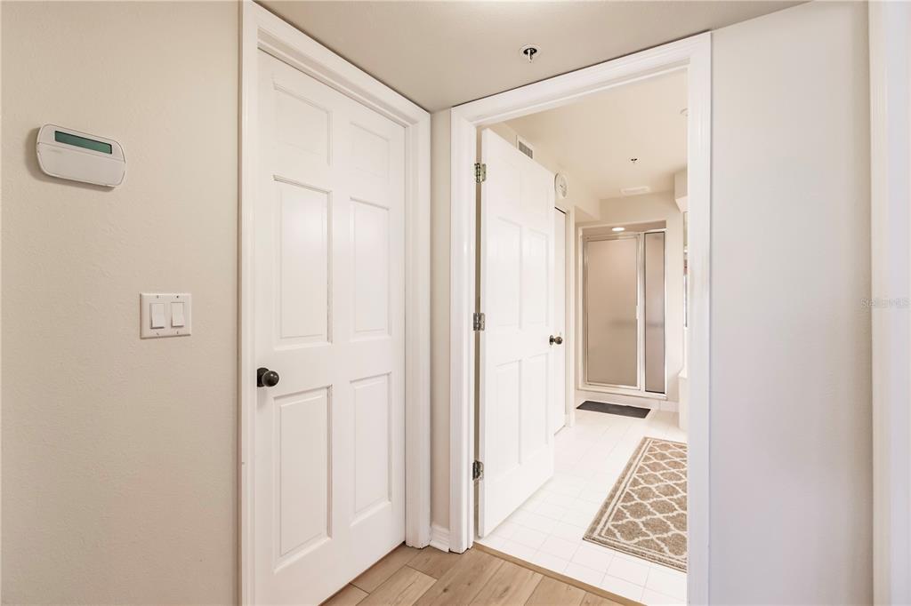 11000 Placida Road, Unit 2201 Placida, FL 33946 - Photo 27 of 43 a view of a hallway with wooden floor and a bathroom