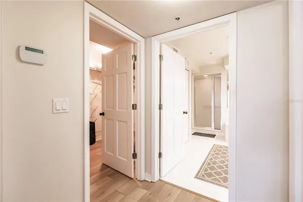 a large white bathroom with a sink a mirror and a shower