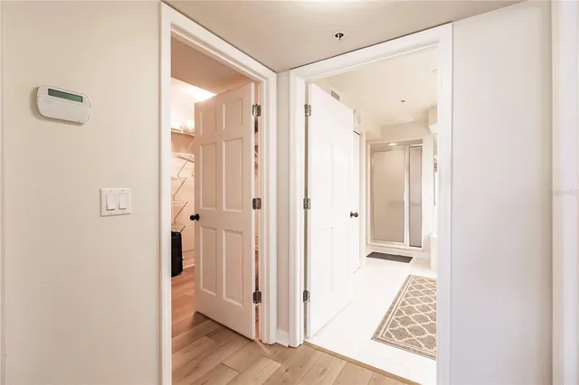 a large white bathroom with a sink a mirror and a shower