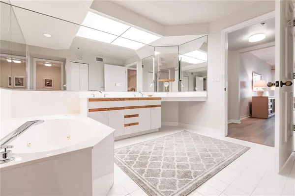 a bathroom with a double vanity sink mirror double and shower