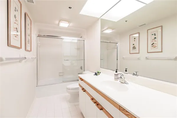 a bathroom with a sink a toilet and mirror