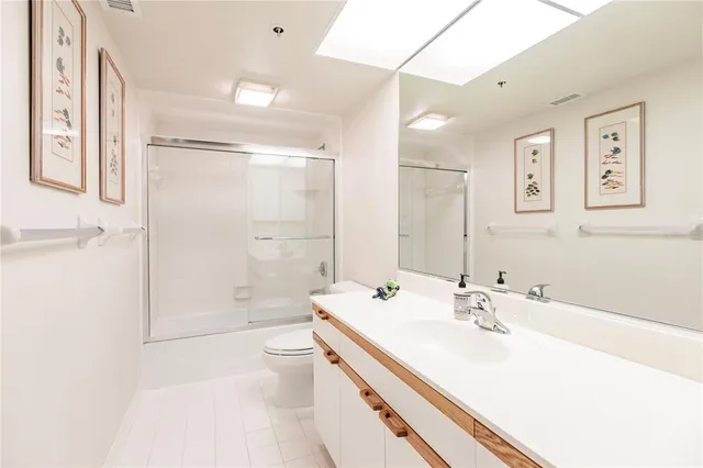 a bathroom with a sink a toilet and mirror