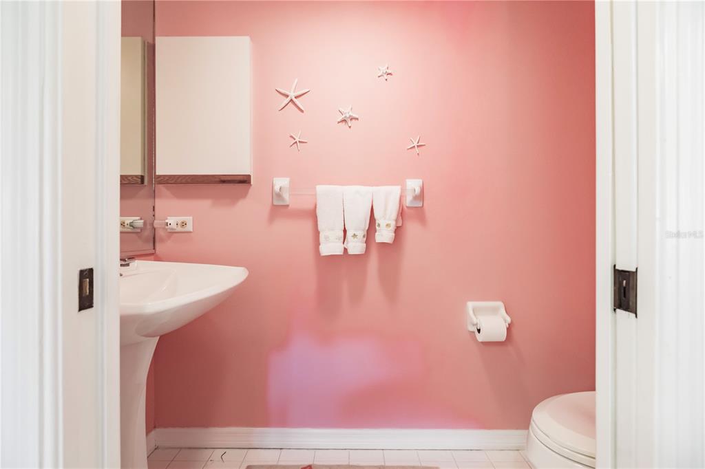 11000 Placida Road, Unit 2201 Placida, FL 33946 - Photo 39 of 43 a bathroom with a sink a toilet and mirror