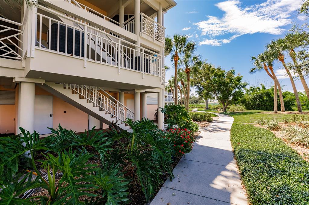 11000 Placida Road, Unit 2201 Placida, FL 33946 - Photo 4 of 43 a view of a house with brick walls and a pathway in a yard