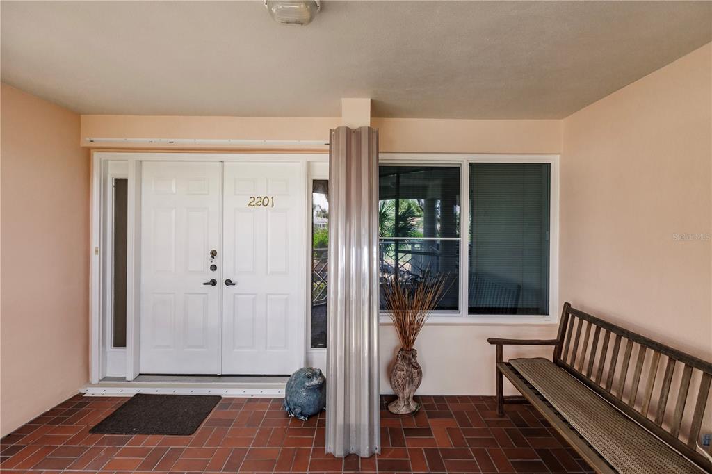 11000 Placida Road, Unit 2201 Placida, FL 33946 - Photo 9 of 43 a view of a hallway with wooden floor and staircase