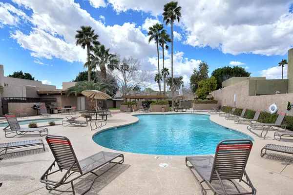 a view of a swimming pool with outdoor seating space