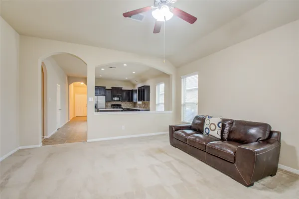 a living room with furniture and a chandelier