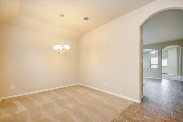 a view of a room with wooden floor and windows
