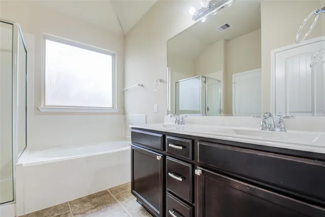 a bathroom with a granite countertop sink a toilet and bathtub