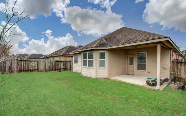 a view of a house with a yard and sitting area