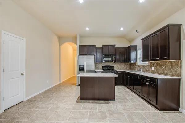 a large kitchen with stainless steel appliances lots of counter top space