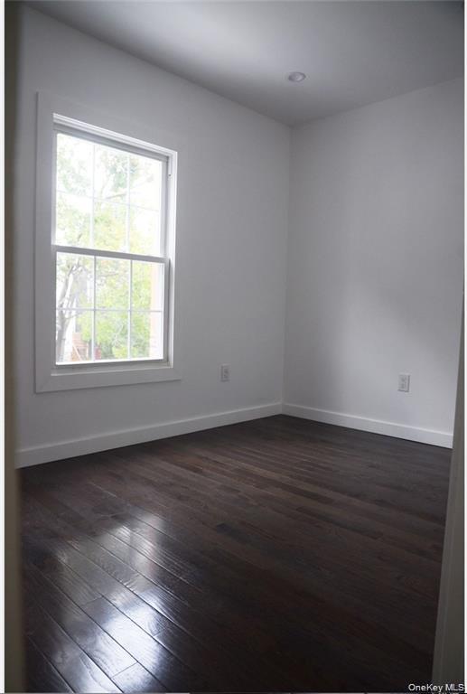 235 East 235th Street Bronx, NY 10470 - Photo 12 of 13 an empty room with wooden floor and windows