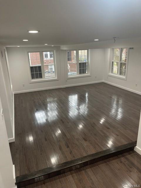 235 East 235th Street Bronx, NY 10470 - Photo 4 of 13 a view of empty room with wooden floor and fan