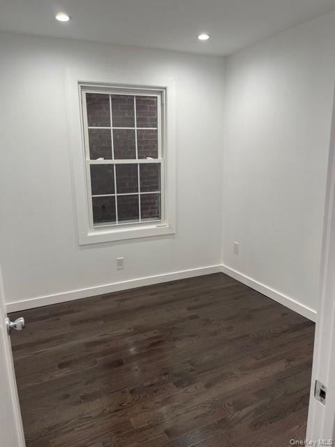 235 East 235th Street Bronx, NY 10470 - Photo 5 of 13 an empty room with wooden floor and windows