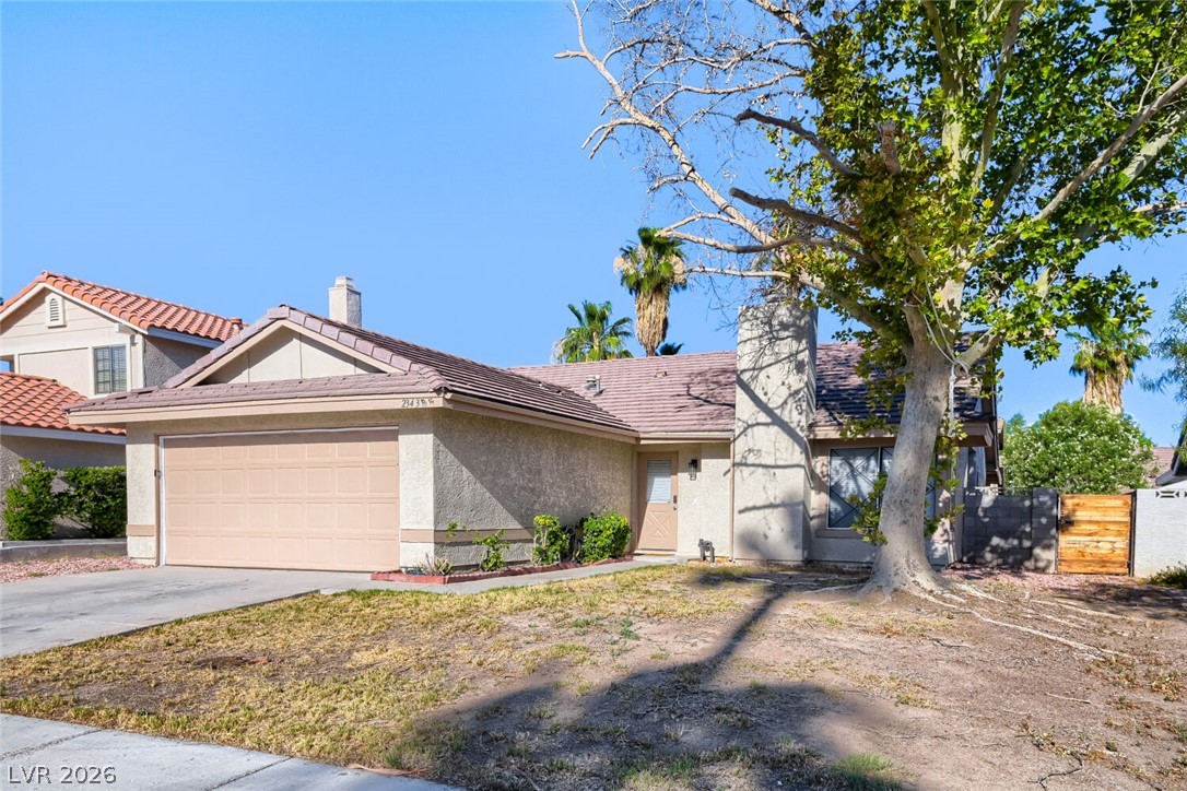 2343 Valleywood Road Henderson, NV 89014 - Photo 4 of 29 A well-maintained stucco home with a two-car garage awaits.