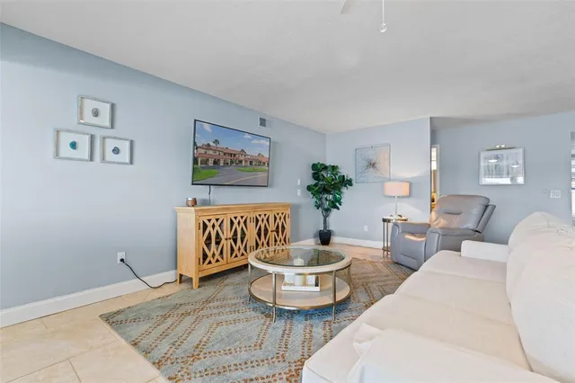 a large kitchen with stainless steel appliances granite countertop a lot of cabinets and refrigerator