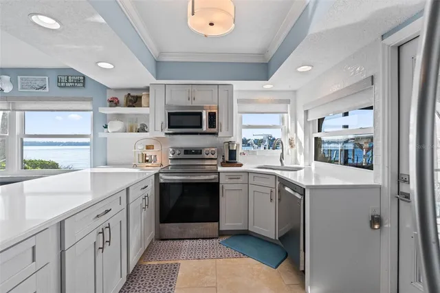 a kitchen with a sink stove and microwave