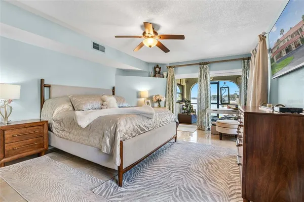 a bedroom with a bed and a chandelier