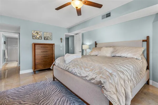 a bedroom with a bed and a large window