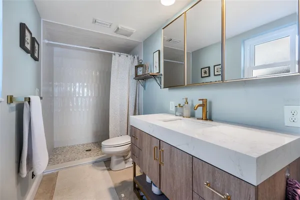 a bathroom with a sink toilet and shower