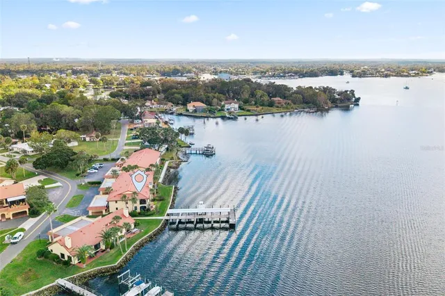 a view of a white house with a yard and sitting area